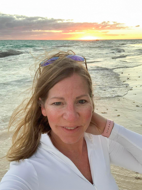 A selfie of Nicky on the beach as the sun sets.